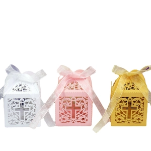Laser-cut hollow cross wedding favor boxes with ribbon bows in white pink and gold