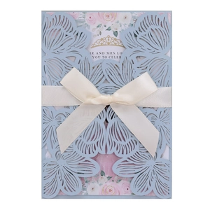 Elegant laser-cut light blue wedding invitation with butterfly patterns and ribbon bow