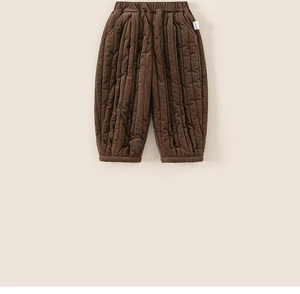 Detailed close-up of brown quilted toddler pants with elastic waist and ribbed cuffs