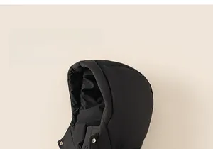 Detail view of the black down jacket hood with matte fabric and metal snap buttons