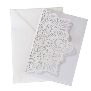 Intricate laser-cut white business wedding invitation with floral mandala pattern and envelope
