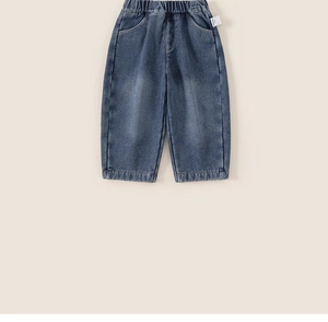 Detail view of children's fleece-lined denim pants with elastic waist and vintage wash finish