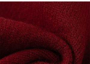 Close-up of wine red chunky knit sweater fabric with warm ribbed texture detail