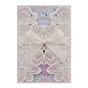 Elegant ivory laser cut wedding invitation with cream ribbon and floral inner card