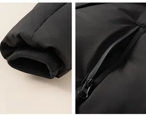 Detail of windproof ribbed cuffs and secure zipper pocket on black winter down jacket