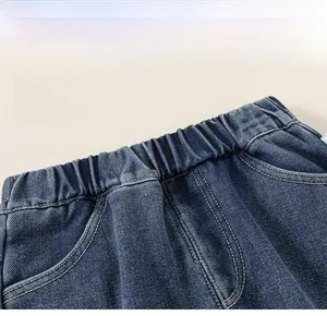 Detail of high-elasticity ribbed waistband on kids deep blue denim pants with neat stitching