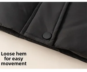 Detail of loose hem and matte black snap button on warm winter down jacket for girls