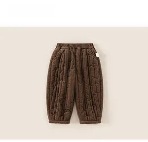 Detail view of dark brown quilted thermal winter trousers for toddlers with elastic waist