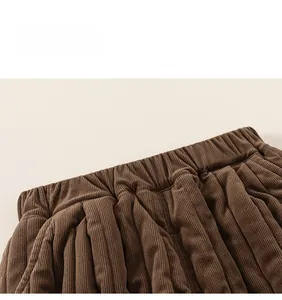 Detail of children's corduroy pants showing the elastic waistband and thick textured fabric