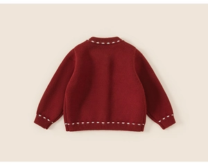 Back view of a red infant knit cardigan with white hand-stitched detailing and thick texture