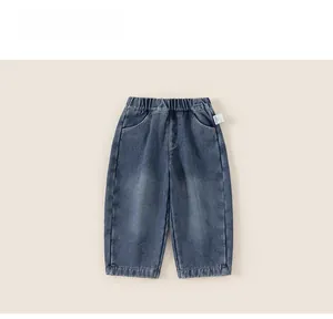 Detail of kids thermal denim pants featuring elastic waistband and blue washed texture