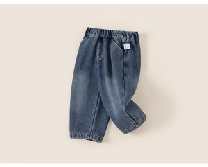 Detail view of children's blue denim pants with elastic waistband and soft wash finish