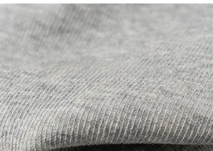 Macro shot of gray knitted cotton fabric texture with circular weave details for leggings
