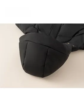Detail view of a black hooded down jacket featuring premium quilting and windproof fabric