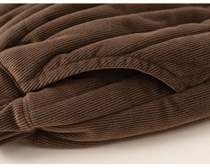 Detail of brown corduroy kids' pants showing side pocket and high-quality warm texture