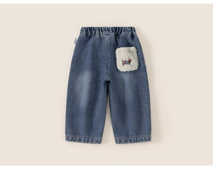 Detail of blue denim trousers with elastic waistband and white plush puppy pocket