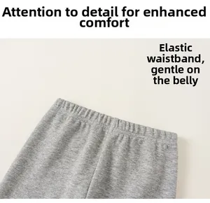 Detail of high-elastic waistband on grey knitted cotton trousers for toddler girls
