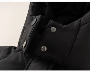 Close-up of black windproof down jacket collar showing snap buttons and fine stitching