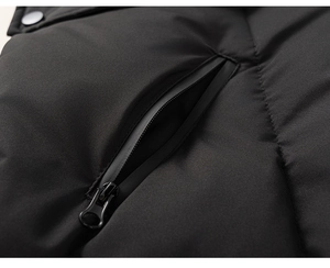 Macro detail of waterproof zipper pocket and metal snap button on girls winter down jacket