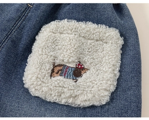 Detail of kids navy denim jeans with a cozy sherpa patch featuring a cute dog embroidery