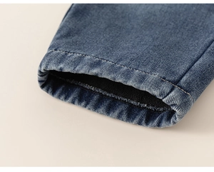 Close-up of kids warm jeans showing deep blue denim and thick black fleece lining