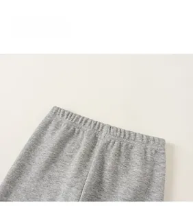 Detail view of the elastic waistband on gray ribbed knit pants for girls