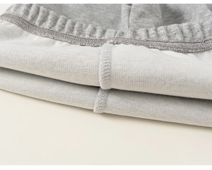 Close-up of high-quality grey knit leggings featuring durable four-thread overlock stitching