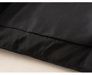 Detail of the high-quality stitching and windproof fabric on a black winter down jacket