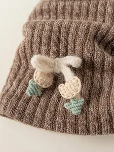 Deep khaki knit beanie with handcrafted crochet cherry detail and green leaf accents