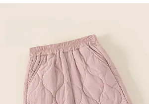 Detail shot of pink quilted pattern on kids winter trousers with elastic waistband