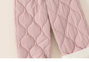 Detail of pink quilted kids winter pants with warm white sherpa lining at the cuff