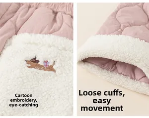 Detail of pink quilted kids pants featuring cute dog embroidery and warm fleece cuffs