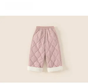 Close-up of pink quilted kids winter pants featuring a warm white fleece lining at the cuffs