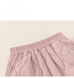 Close-up of pink quilted kids' warm pants featuring elastic waistband and wave stitching