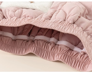 Detail of pink quilted thermal pants showing soft fleece lining and elastic waistband
