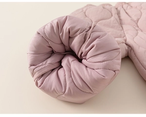 Detail of pink quilted sleeve cuff with wavy stitching on children winter pants