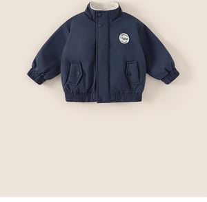 Close-up of navy blue winter jacket featuring warm white fleece lining and vintage patch