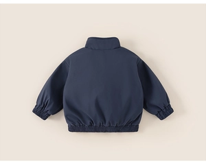 Detail view of the windproof dark blue kid jacket back featuring elastic cuffs and hem