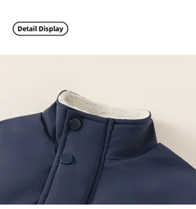 Close-up of navy boy jacket collar with warm white shearling lining and matte snap buttons