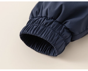 Detailed close-up of windproof elastic cuffs on navy blue kids outdoor jacket