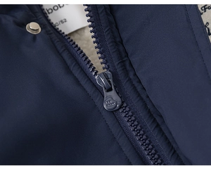 Detail of navy windproof fabric with warm grey fleece lining and secure zip closure