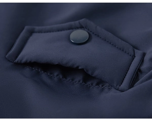 Detailed close-up of the dark blue jacket pocket featuring a single round button and fine stitching