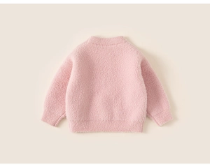 Detail view of pink fuzzy mohair knit sweater showing the soft texture and ribbed hem