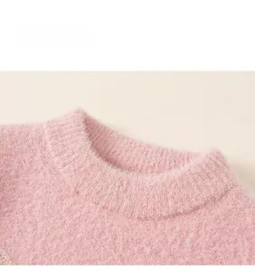 Close-up of the plush pink faux mink sweater collar featuring ribbed crew neck detail
