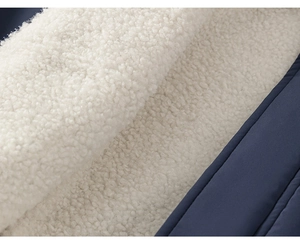 Detailed macro view of dark blue fabric with thick white sherpa fleece lining for warmth