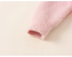 Close-up of pink fluffy knit sweater sleeve with soft ribbed cuffs and fuzzy texture