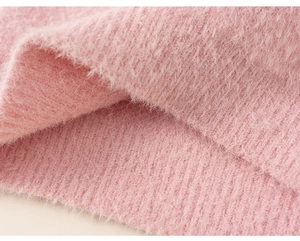 Close-up of soft pink ribbed knit fabric with fluffy mink-like plush texture and thickness