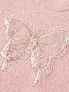 Pink plush sweater for girls featuring a decorative butterfly with pearls and sequins