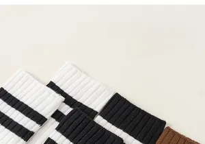 Detail shot of seamless rib-knit cotton socks for girls with striped cuffs and soft texture