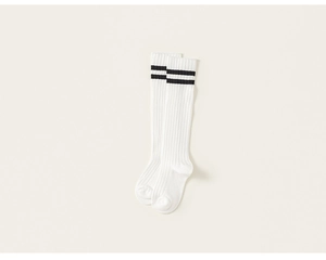 Close-up of ivory knit knee-high socks with classic black double stripes in preppy style